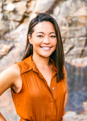 a medium shot of the Bluebird's Co-Founder Riye Ara-Coupe wearing an orange top