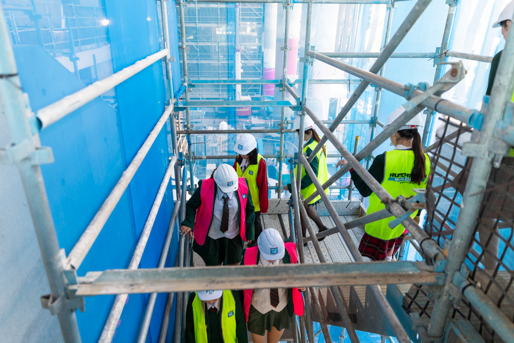 young girls leaving a construction site
