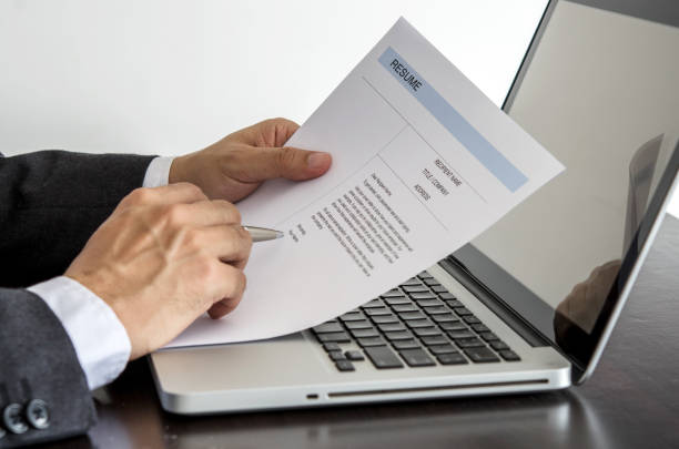 An image of a person crafting an insurance agent resume on a laptop