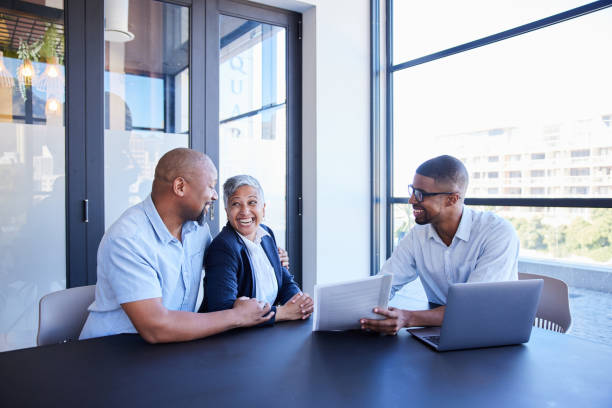 Insurance agent conversing with a client via a laptop.