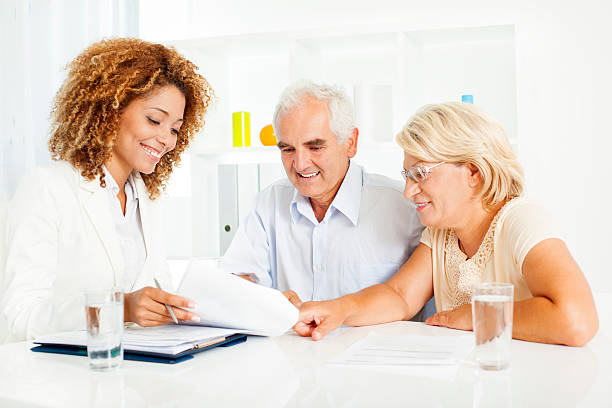 Insurance agent assisting client with documents.