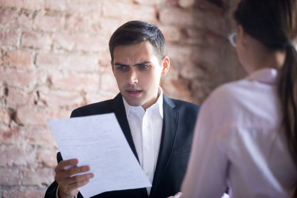  person looking at paperwork with a confused expression.