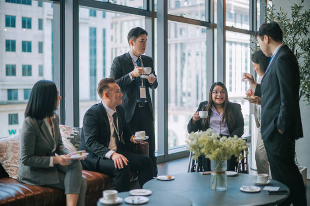  Diverse group of insurance agents engaged in a professional discussion, surrounded by modern office equipment