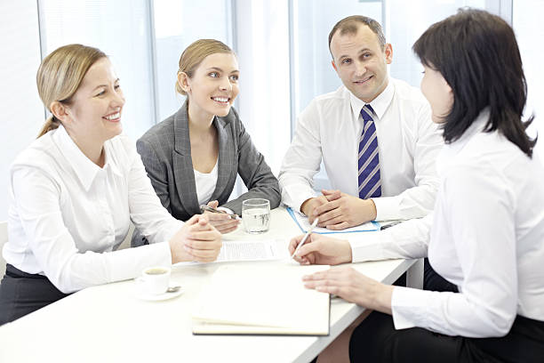 Group of diverse insurance agents engaged in professional conversations showcasing effective communication skills for success in the life and health insurance industry