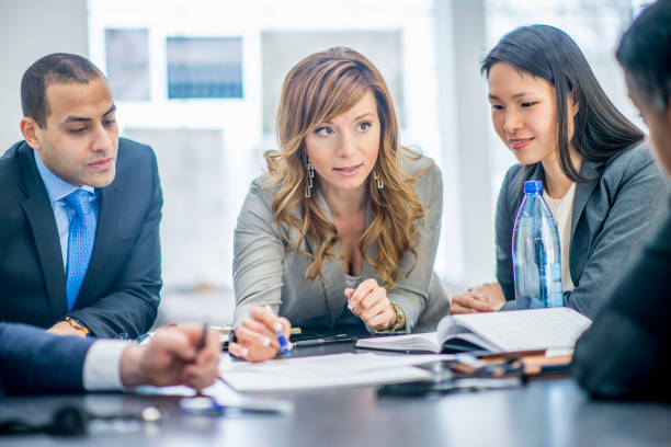  Insurance agent presenting insurance options to a group of clients.