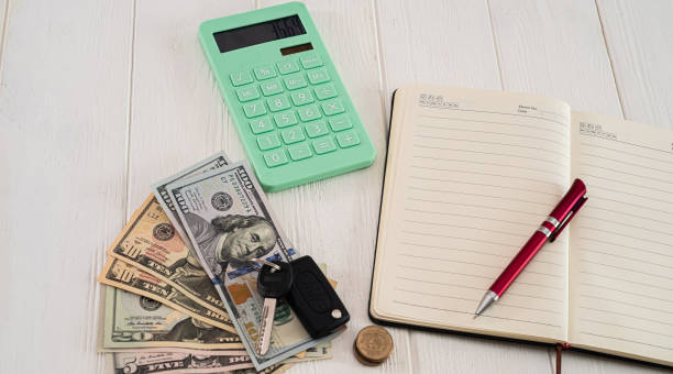 pen and a notebook on a desk with an insurance brochure and calculator.