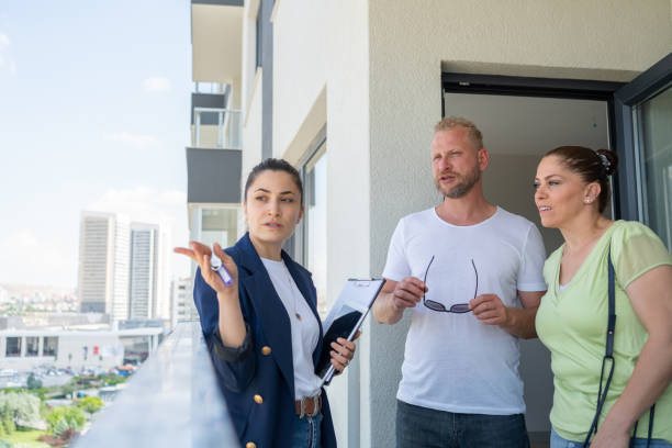 Female insurance agent discussing coverage with a couple.