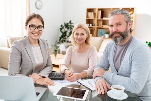 A team of agents discussing insurance policies and writing reports in a workplace.