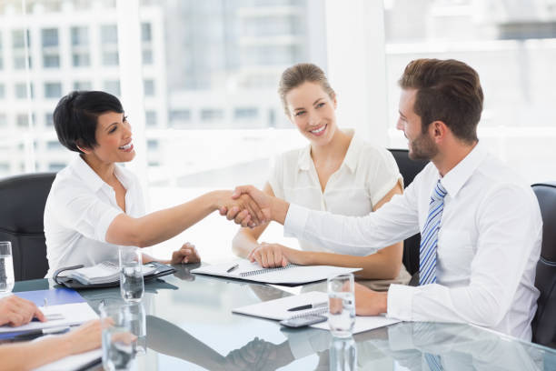 A diverse group of professionals working together in a bright and welcoming office, representing top insurance companies to work for in 2023.