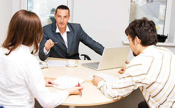A professional insurance agent advising a client, showcasing the benefits of insurance agent certification for career advancement.