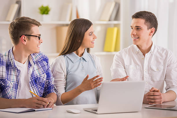 An insurance sales agent giving an in-home sales pitch to a couple.