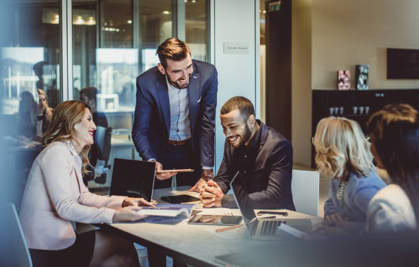  A group of professionals meeting to discuss insurance sales tactics.