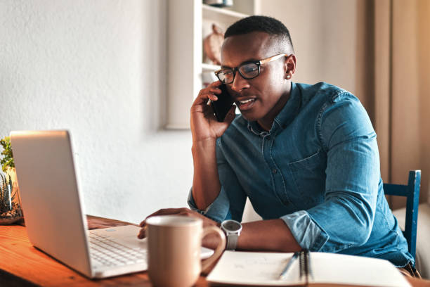 A person confidently talking on the phone with a lead.