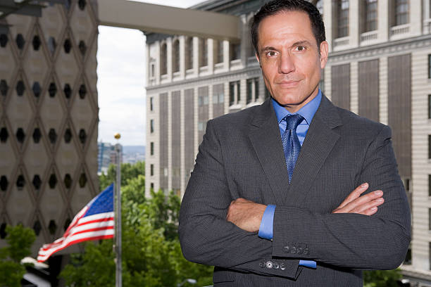  A photo of an individual standing in front of his government building expressing interest to become an insurance agent, depicting motivation topic-wise.