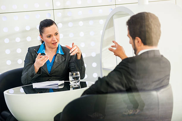 Friendly agent and happy client sitting together going over policy options.
