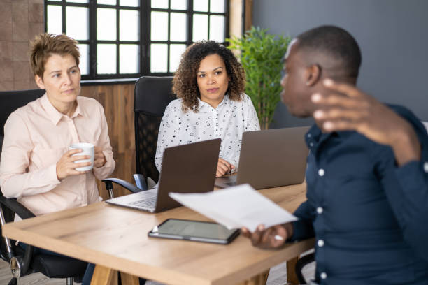 : "A group of diverse insurance agents discussing strategies in a modern office, symbolizing the rise of independent insurance agent jobs."