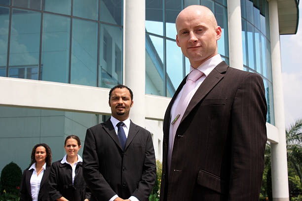 Elite Life Agency team standing in front of office building.