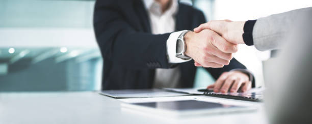 Two hands shaking indicating a successful negotiation.
