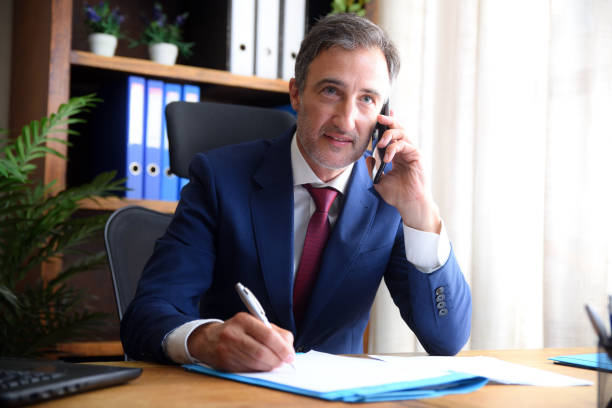 A professional insurance agent at work, serving a client over the phone, demonstrating competence in the field of insurance.