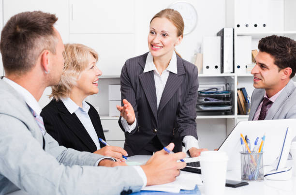 A group of licensed insurance agents collaborating and analyzing policies in a modern office setting.