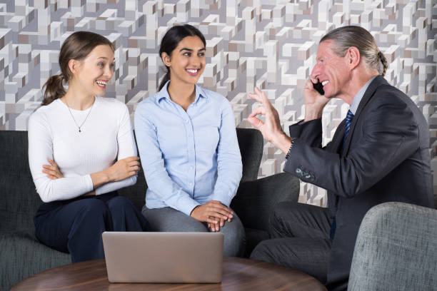 "Group of diverse insurance agents discussing policies and interacting with clients, exemplifying top-performing qualities and skills."