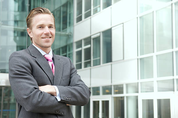 Professional image of an insurance agent in formal attire standing in front of a city skyline.