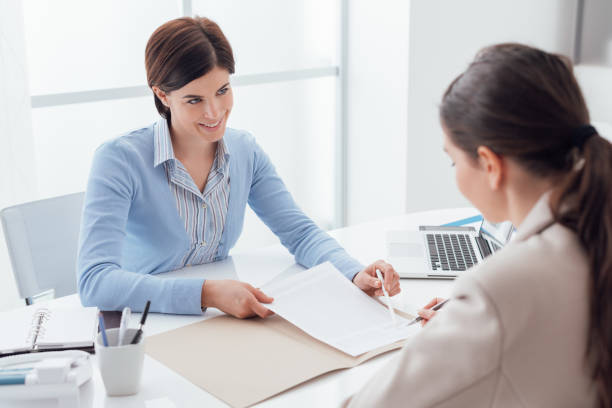 "Insurance agent providing professional advice to a client in a professional setting."