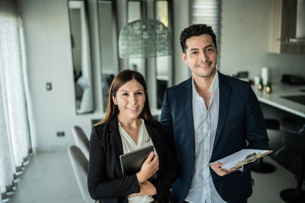 Successful insurance agent holding clipboard and smiling.