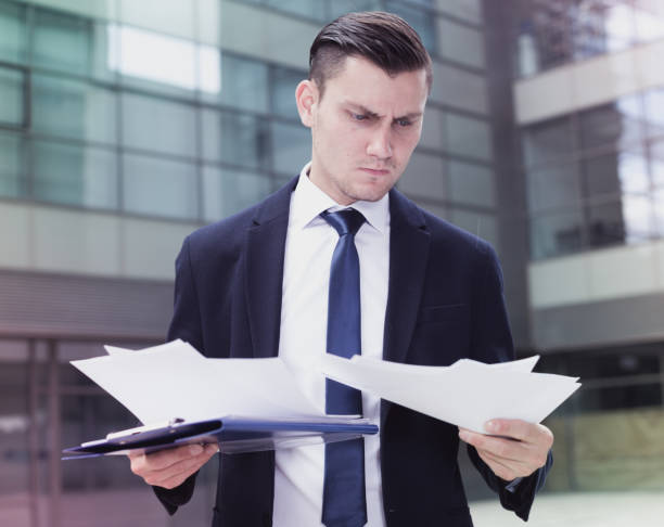 Confused man symbolizing the frustration of navigating the complex licensing regulations of the insurance industry.