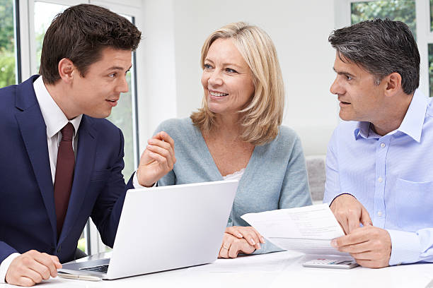 Image of a life insurance agent speaking with a couple about their life insurance policy.