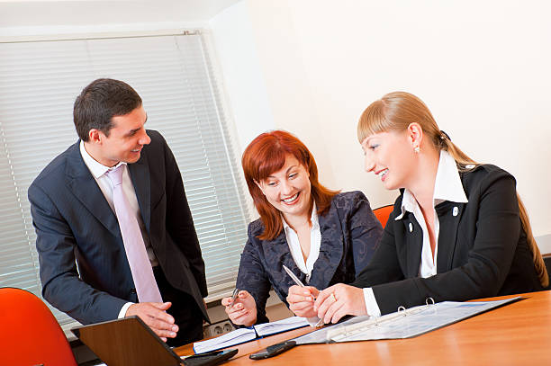 A professional insurance agent discussing life and health insurance with a client, showcasing the necessary skills and expertise in the industry.