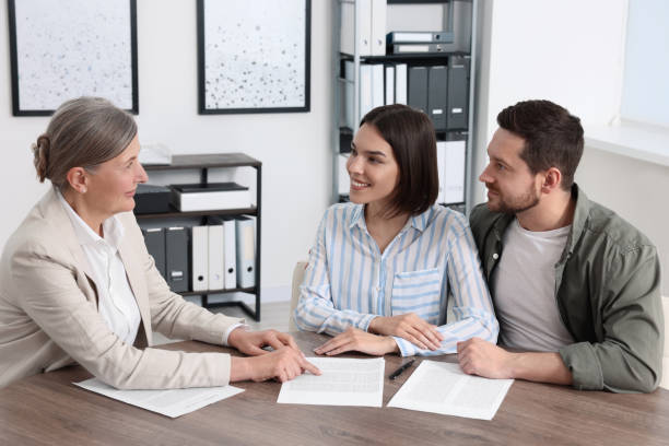 A happy agent assisting a satisfied customer with an insurance policy.