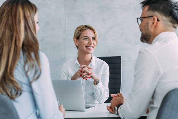 A group of diverse health insurance agents working in an office, reflecting a supportive and interactive workplace culture in the health insurance industry.