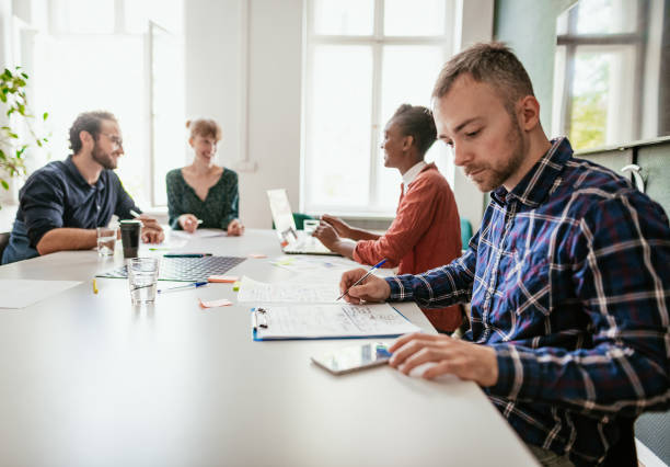 A diverse group of professionals working together in an office environment, representing various unique health insurance agent career paths.