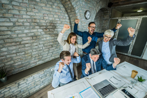 A group of licensed insurance agents working remotely to celebrate a success on video call meeting on a company virtual platform.