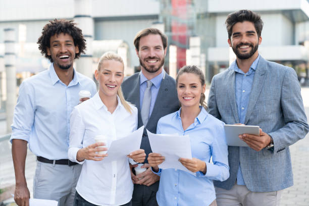 A group of diverse professionals engaged in a discussion, representing the collaborative and dynamic work environment of part-time insurance agent opportunities.