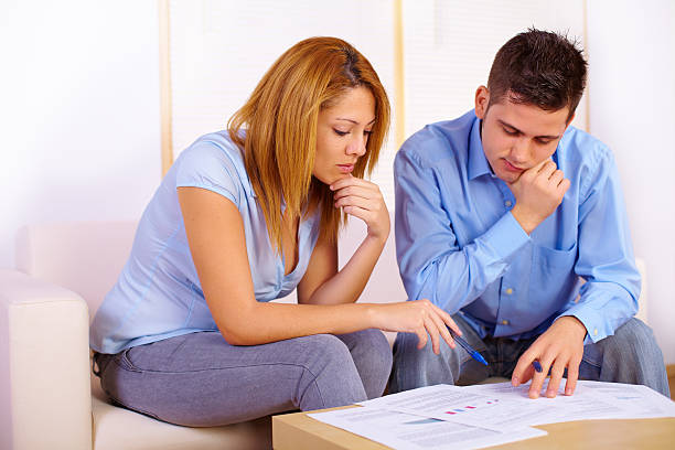A male and female discussing life insurance policies and options.