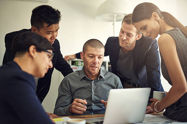 "Image of diverse professionals in a modern office working together on insurance-related tasks to represent the 2023 Average Life and Health Insurance Agent Salary article."