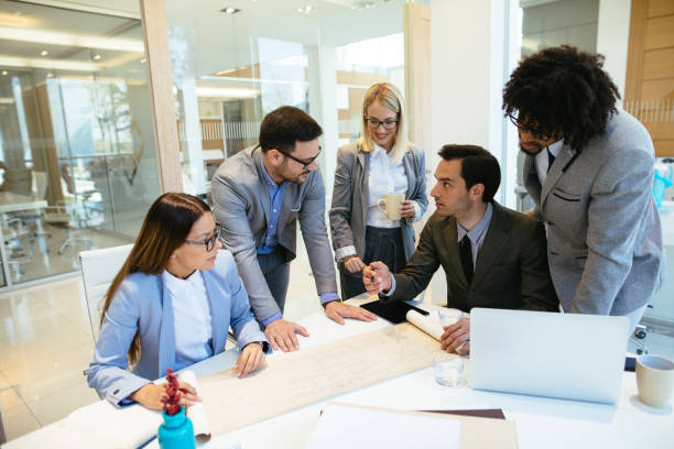 "Diverse insurance agents discussing policies and collaborating in a modern office setting."