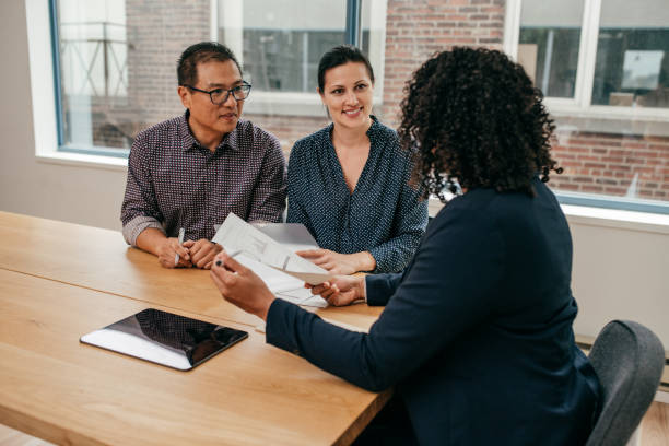 Life and health insurance agent discussing insurance policies with a client, showcasing professional expertise and confidence.