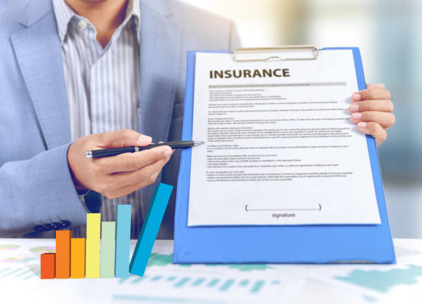  "A diverse group of professionals holding documents and standing in front of an insurance office, representing the licenses required for insurance agent jobs."