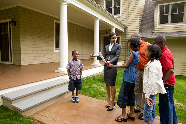 Insurance sales agent discussing policies with a family