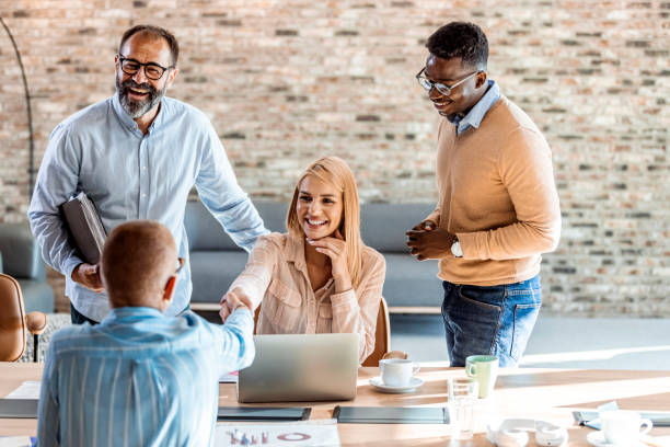 Group of diverse insurance sales agents collaborating in an office.