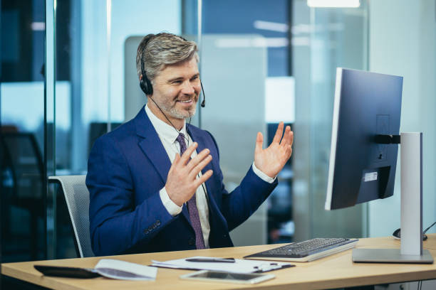  Image of a charismatic and successful insurance agent answering questions at a seminar event while wearing a microphone headset.