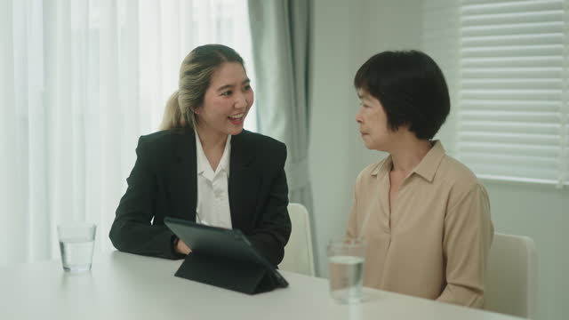 Insurance agent meeting with client to discuss insurance policies