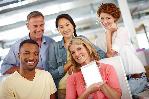 A group of diverse individuals holding insurance agency products and discussing insurance options