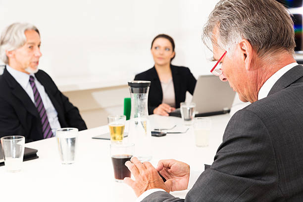  Unlimited growth potential - a group of insurance agents listening to a senior member.