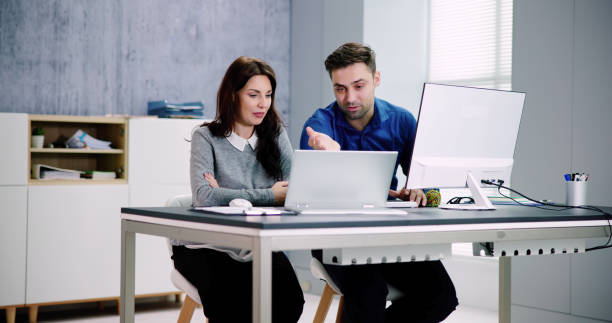 Two life insurance agents working together to sell a policy.