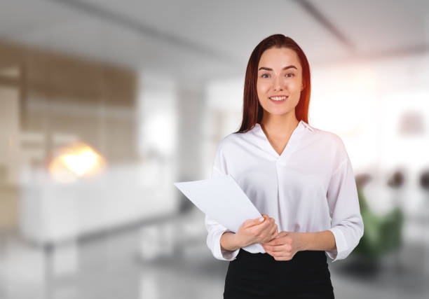 Young insurance agent with clipboard in a professional attire, conveying competence and confidence for the article on the most important skills for entry-level insurance agents.