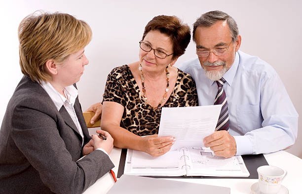 Senior couple discussing car insurance with an agent